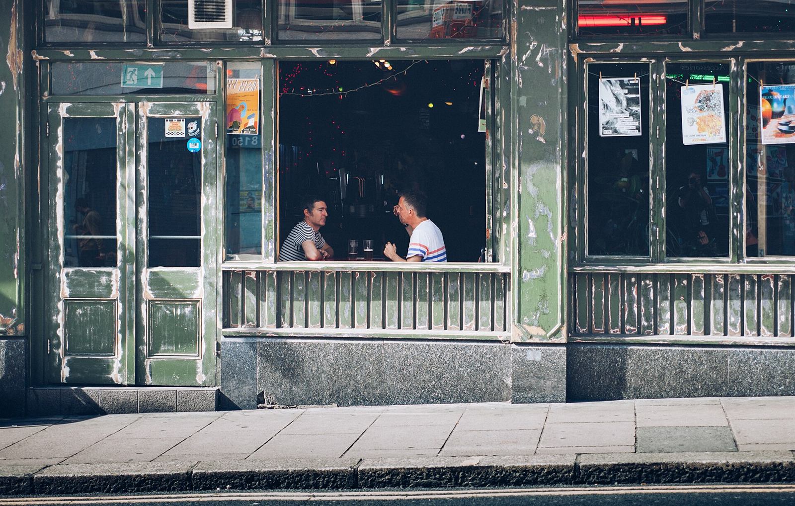 Friends chatting over a drink at a venue