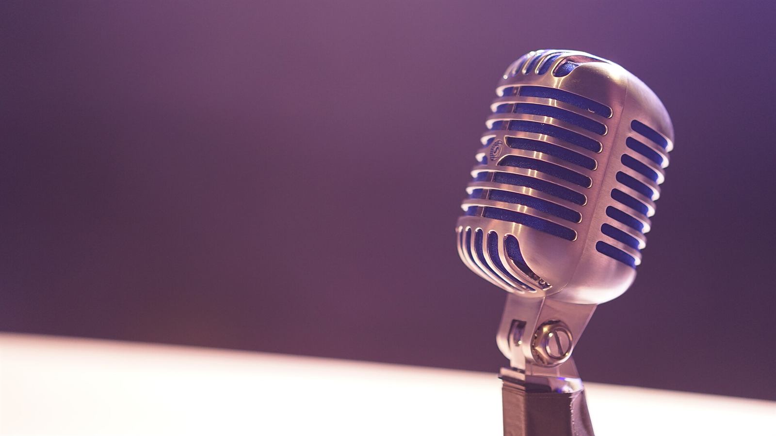 A vintage microphone under purple light